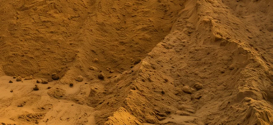A large stockpile of golden filling sand